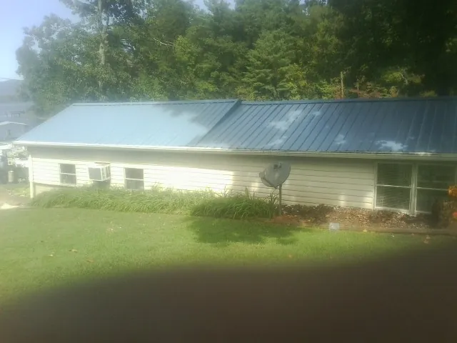 Blue metal roof running the length of a single story home in Watertown